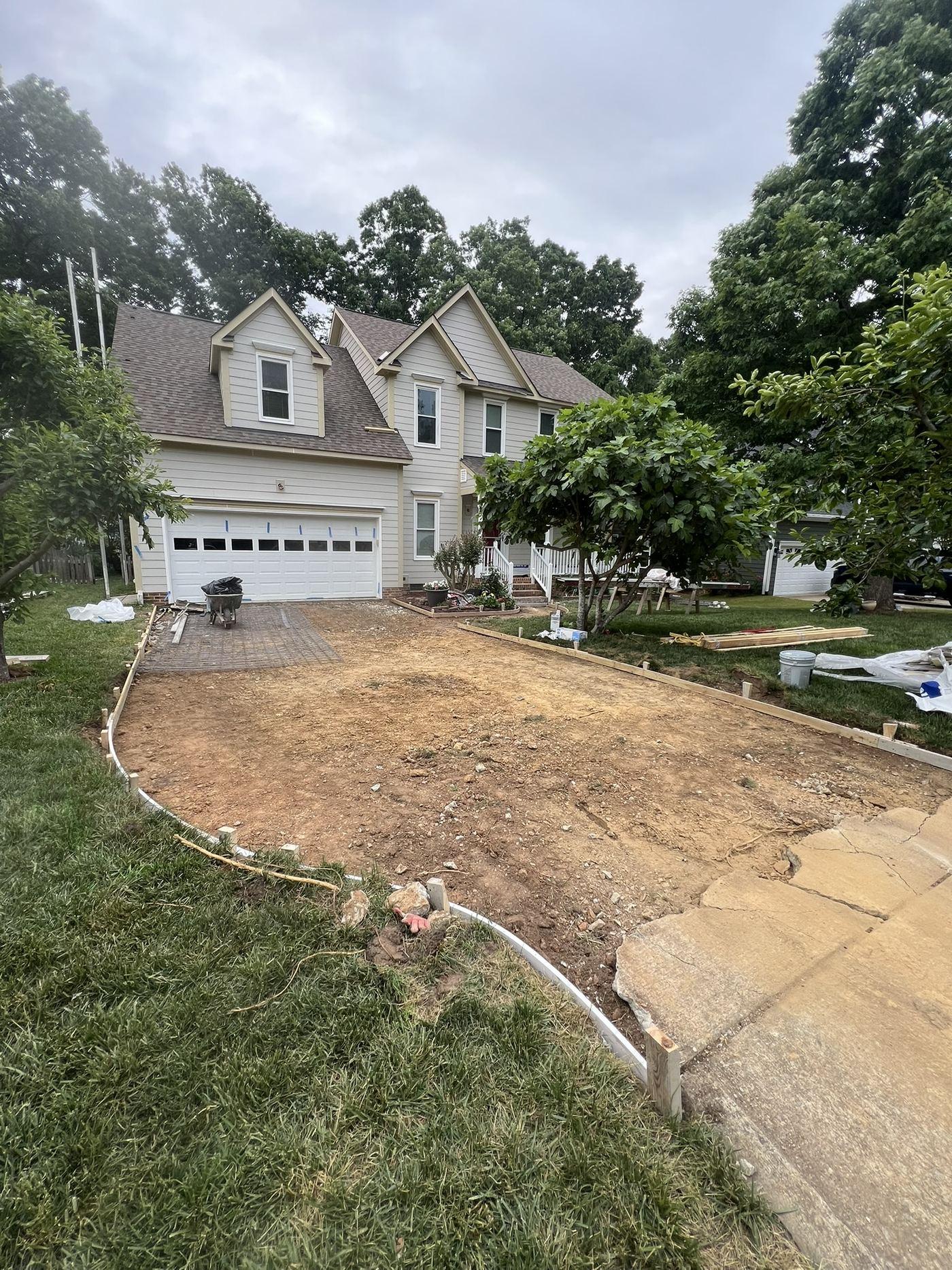 The driveway removed back to bare soil before the replacement slab was poured