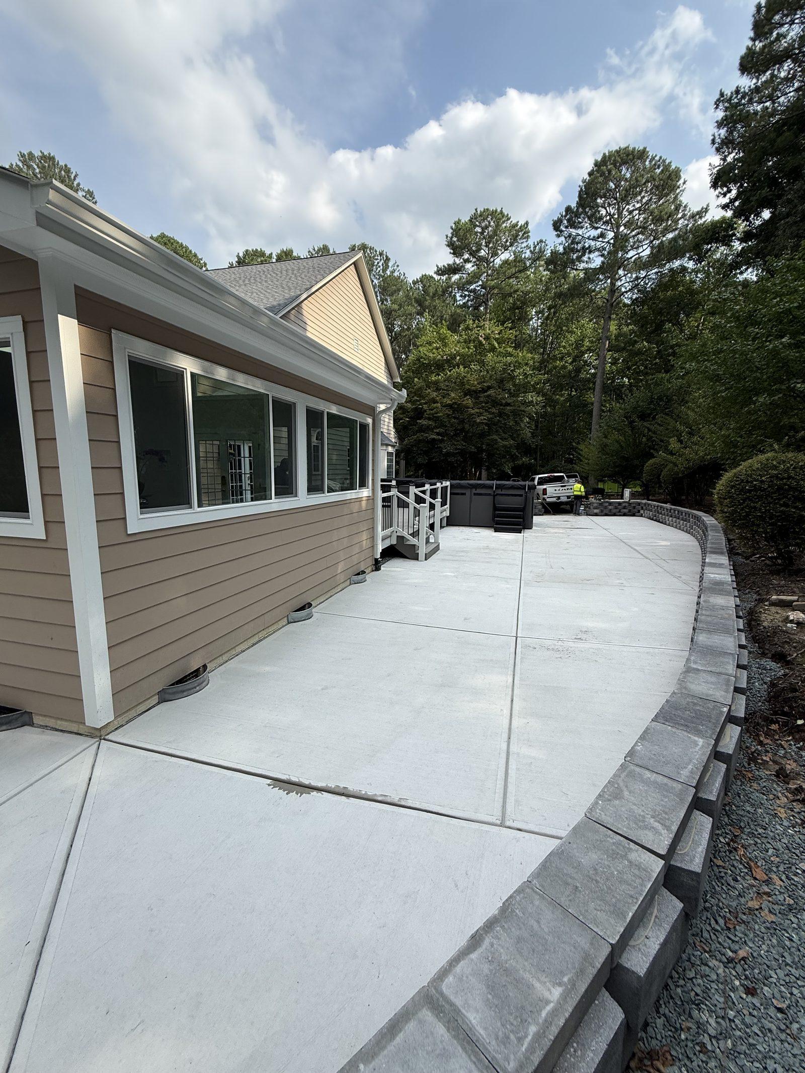 The sunroom that replaced it, clad and trimmed to match the house, with the new patio in front
