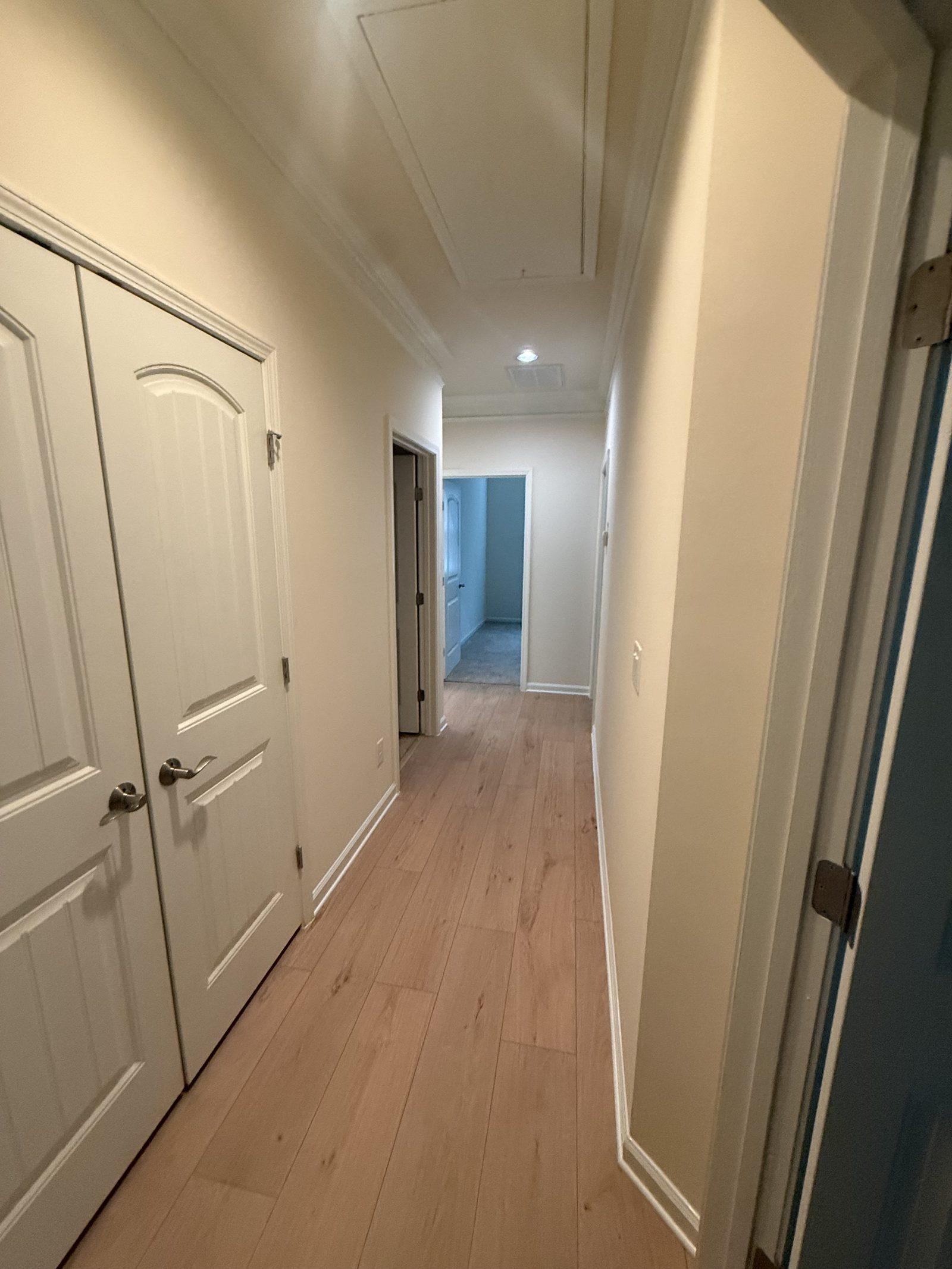 The hallway carrying the same plank floor through to the bedrooms
