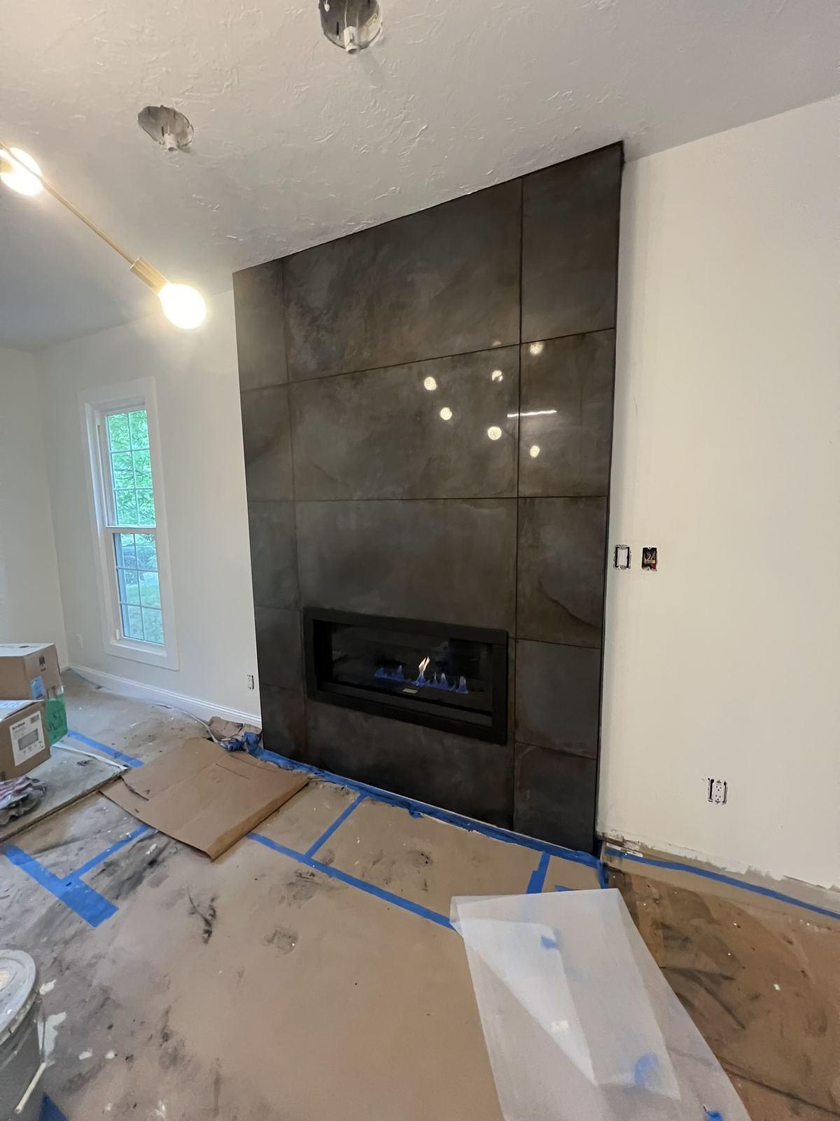 Finished full-height tiled fireplace surround with a linear gas insert