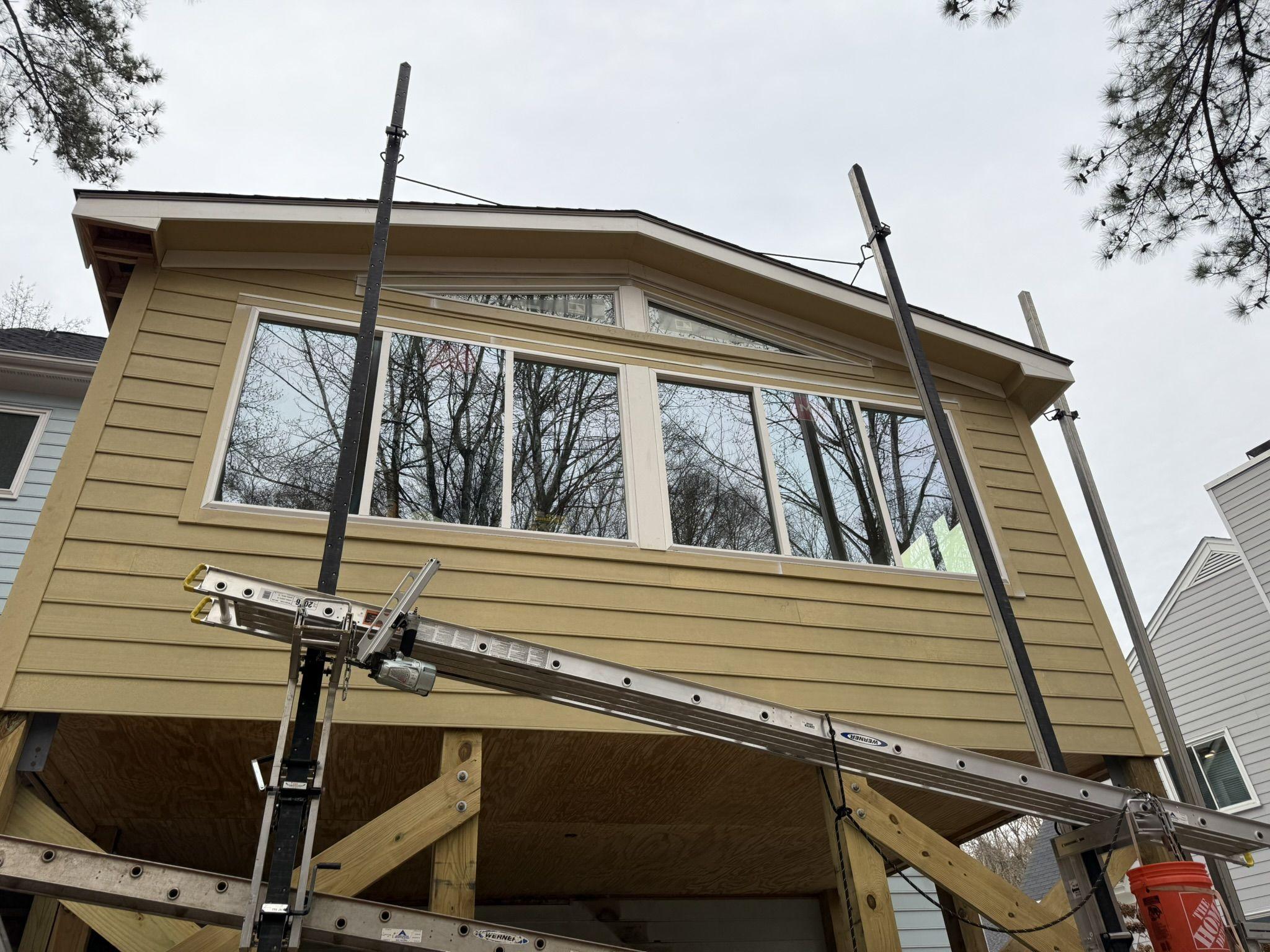 Elevated sunroom addition framed on new posts with temporary shoring and cross-bracing in place — Park Sunroom