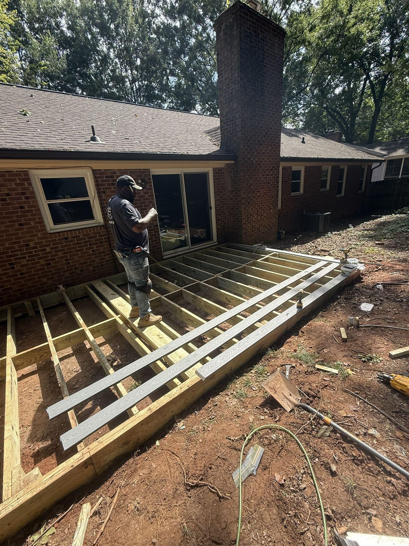 Pressure-treated joists set out across the deck footprint during framing