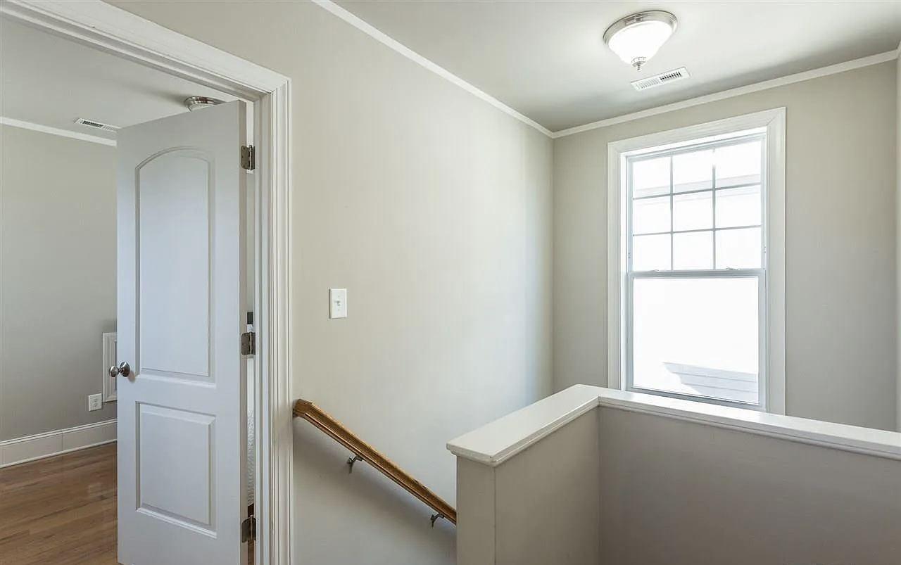 Finished stair landing with handrail and painted trim