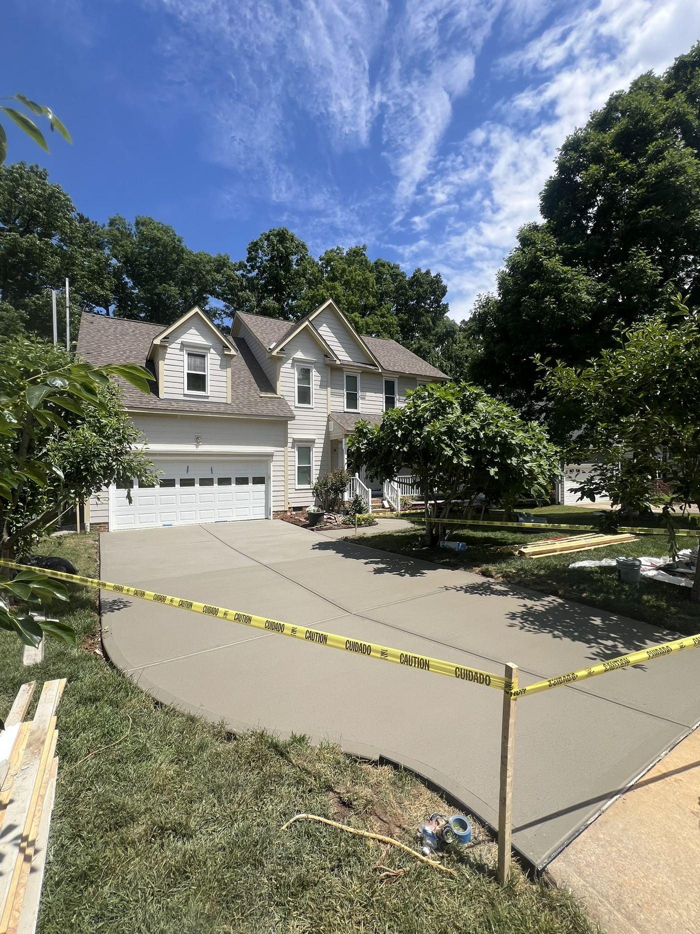 Finished replacement concrete driveway freshly poured