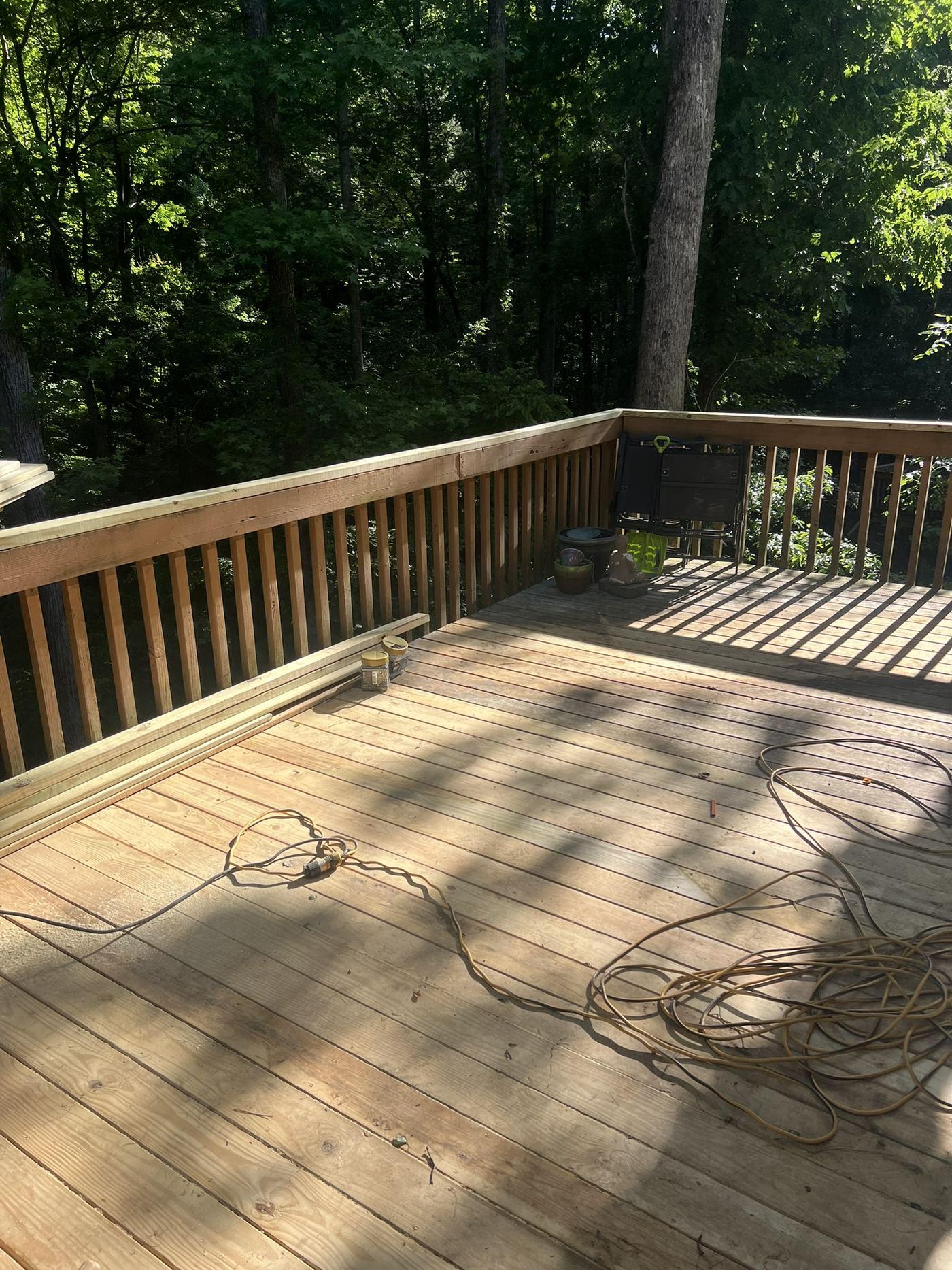 Timber deck completed above a segmental block retaining wall in a wooded rear garden